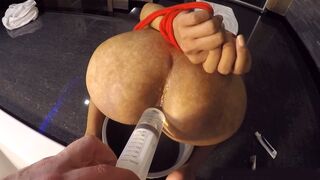 Pissing on big booty of an Asian ladyboy & filling it to squirt